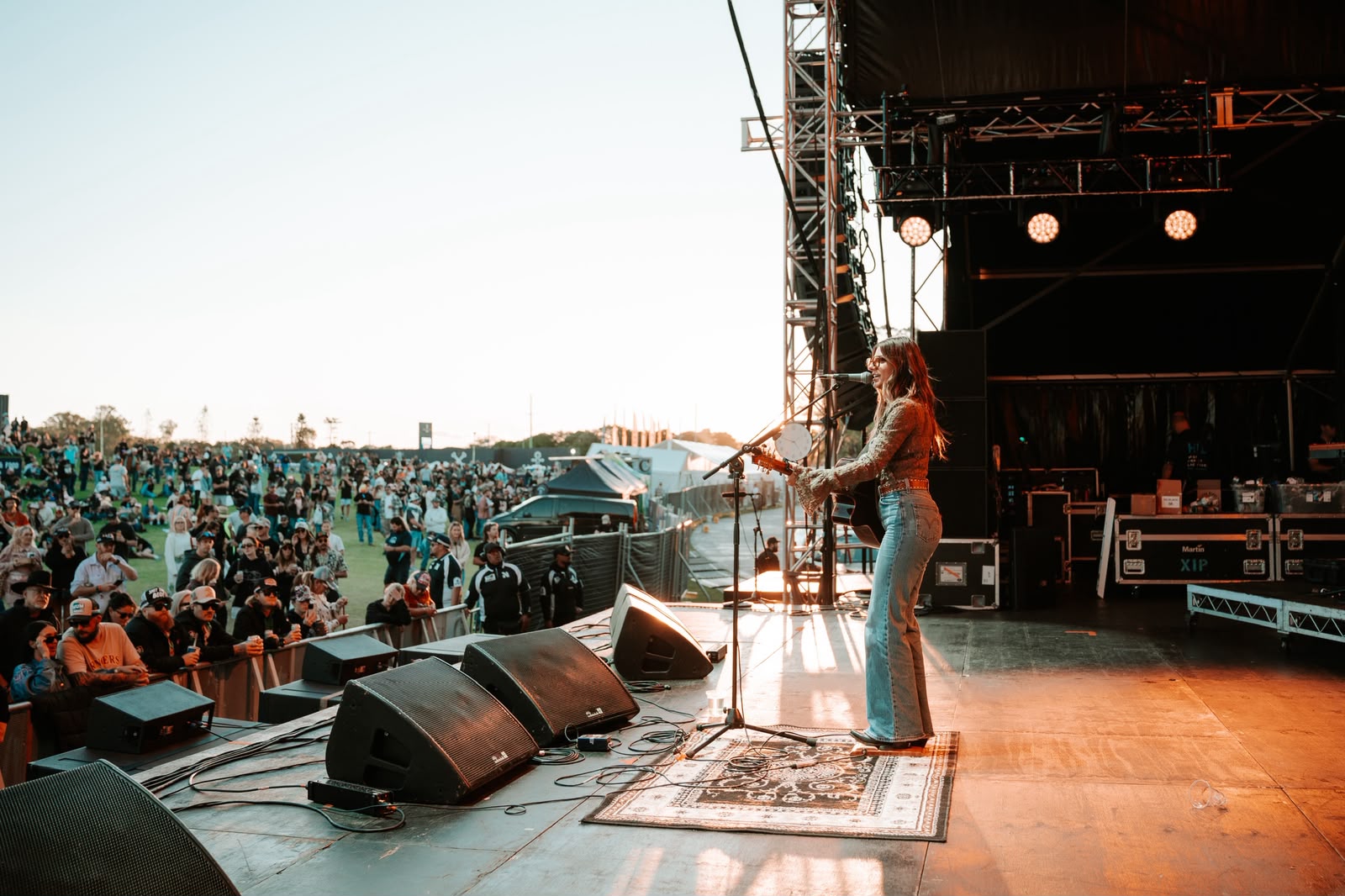 Bianca Joulianou performing live on stage at golden hour
